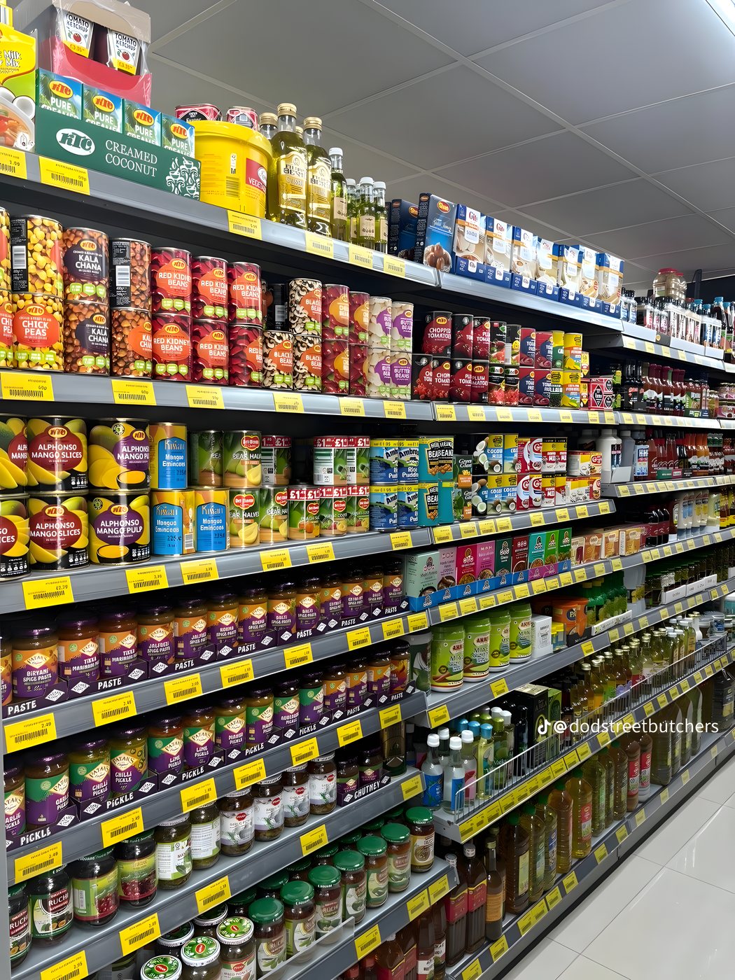 Grocery shelves stocked with pastes, pickles and store-cupboard staples